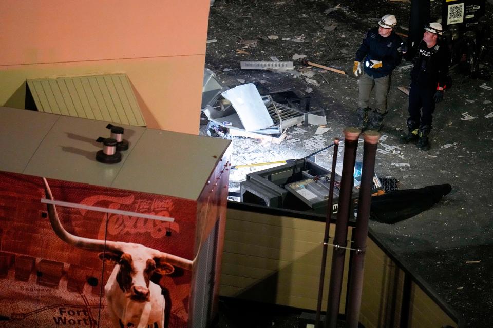 Investigators survey an area near the Sandman Signature hotel following an explosion, Monday, Jan. 8, 2024, in Fort Worth, Texas.