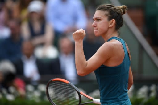 Winning start: Simona Halep shrugged off a terrible first set to see off Alison Riske in her Roland Garros opener