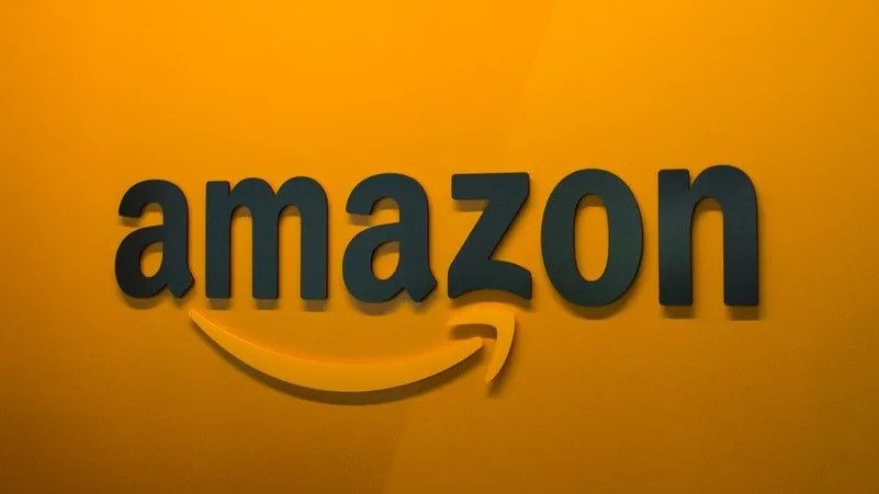 Amazon logo on an orange wall.