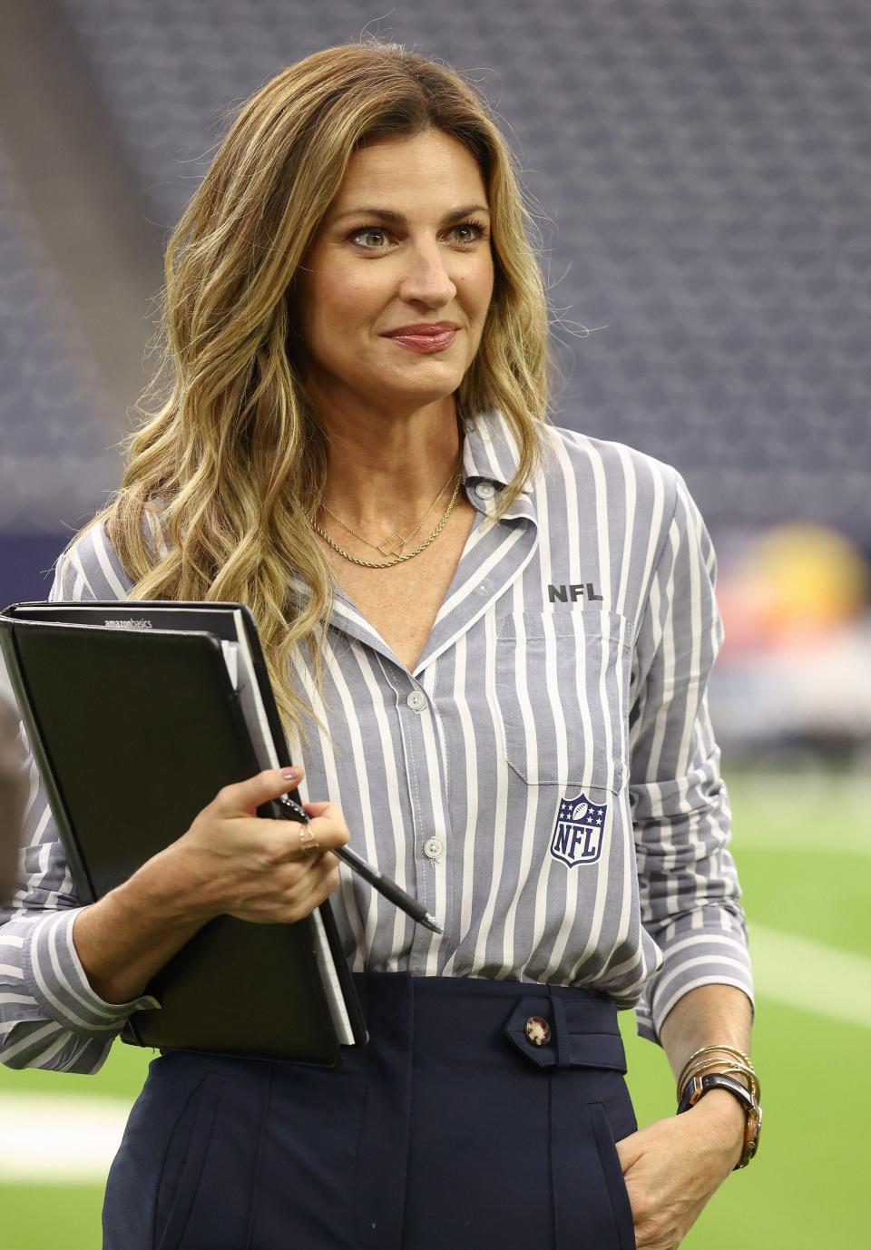 Andrews wears an NFL long-sleeve shirt from her "WEAR by Erin Andrews" collection while reporting on the sidelines of the Carolina Panthers vs Houston Texans game.