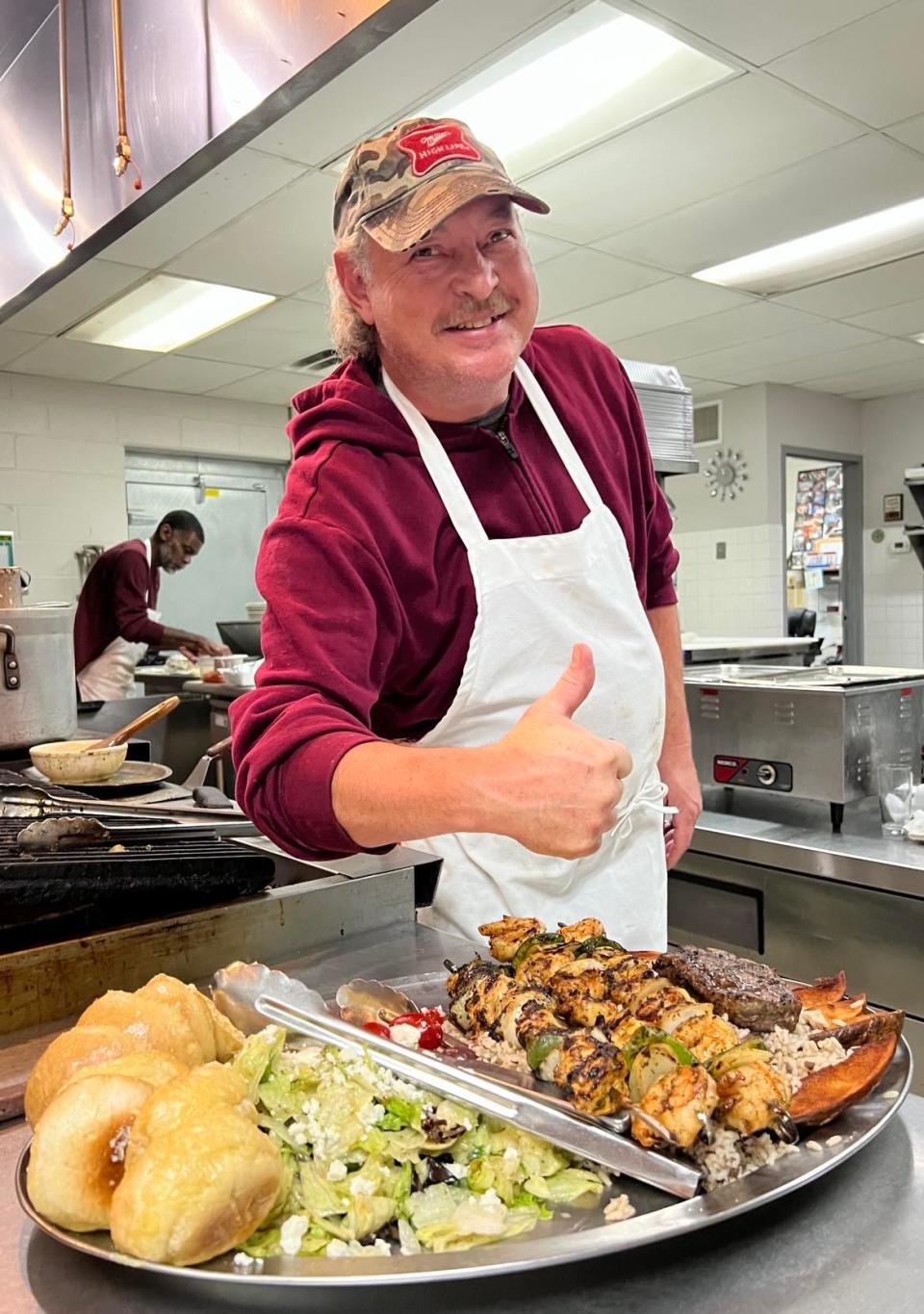 Jason Hershey, a chef at Desert Inn restaurant in Canton, poses for a photo while working in the kitchen.