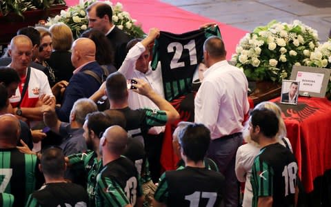 People arrive to attend the state funeral of the victims of the Morandi Bridge collapse, at the Genoa Trade Fair and Exhibition Centre in Genoa