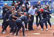 <p>YOKOHAMA, JAPAN - JULY 26: Kelsey Stewart #7 of Team United States jumps on home plate as the umpire and her teammates watch her score the winning run after Stewart hit a walk-off home run in the seventh inning against Team Japan during softball opening round on day three of the Tokyo 2020 Olympic Games at Yokohama Baseball Stadium on July 26, 2021 in Yokohama, Kanagawa, Japan. Team United States defeated Team Japan 2-1. (Photo by Yuichi Masuda/Getty Images)</p> 