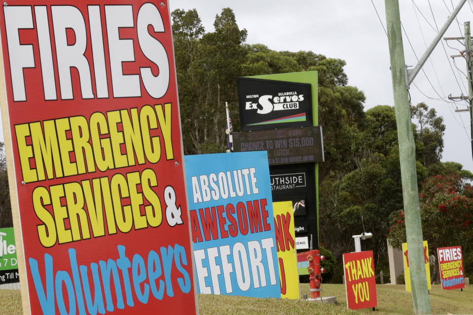 Signs are displayed near Ulludulla, Australia, Thursday, Jan. 9, 2020, thanking "firies" a colloquial term for firefighters. House after house in affected areas have hung makeshift banners offering thanks to the people they call "firies." It's a far cry from how many Australians view their leader, Prime Minister Scott Morrison, who has been widely ridiculed for his response to the disaster. (AP Photo/Rick Rycroft)