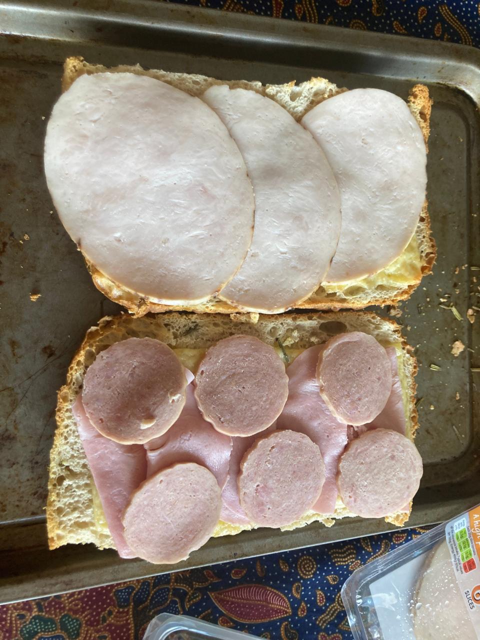 A picture of the focaccia with turkey on one side, and pork slices and thin ham on the other.