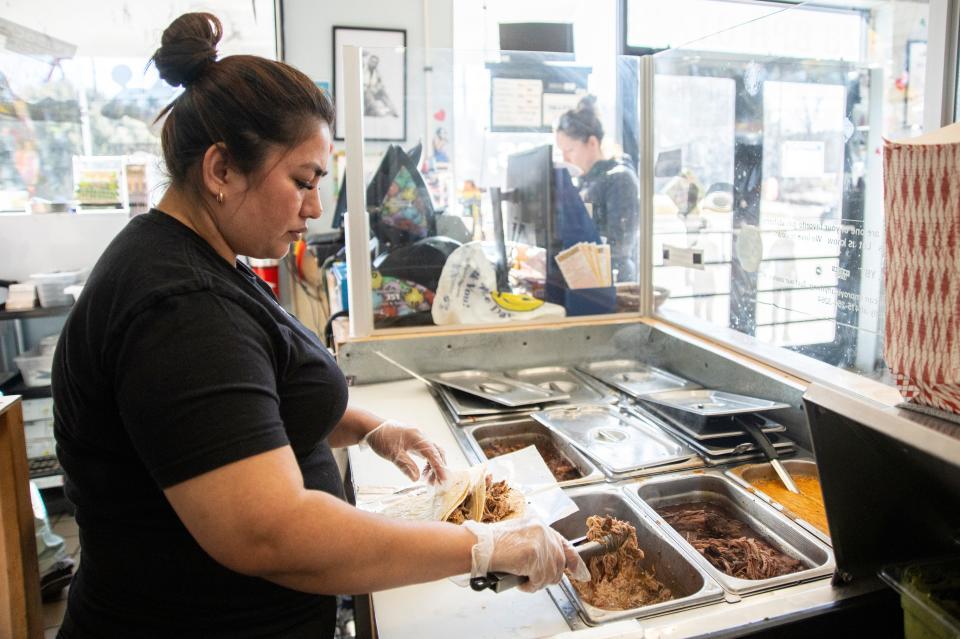 Cook Ingrid Grande makes an order for a customer at Yo!Boca!Taco! on Boston Post Road in Wayland, Feb. 12, 2024.