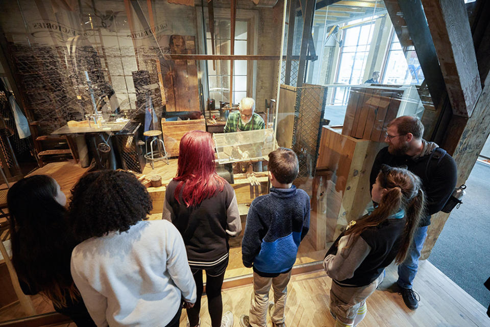 High school students at the Grand Rapids Public Museum School visit a local carpenter restoring vintage furniture in the museum’s archives. The city has a rich history of furniture production and exportation. (Chris Chandler)