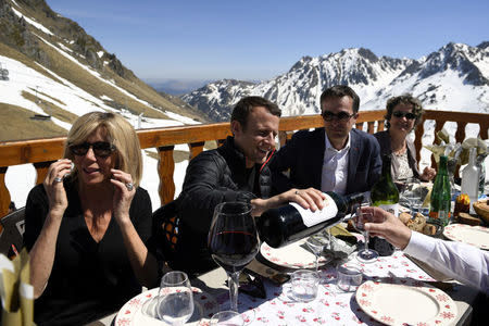 Emmanuel Macron (2ndL), head of the political movement En Marche ! (Onwards !) and candidate for the 2017 presidential election, and his wife Brigitte Trogneux have a lunch break at the mountain top during a campaign visit in Bagneres de Bigorre, in the Pyrenees mountain, France, April 12, 2017. REUTERS/Eric Feferberg/Pool