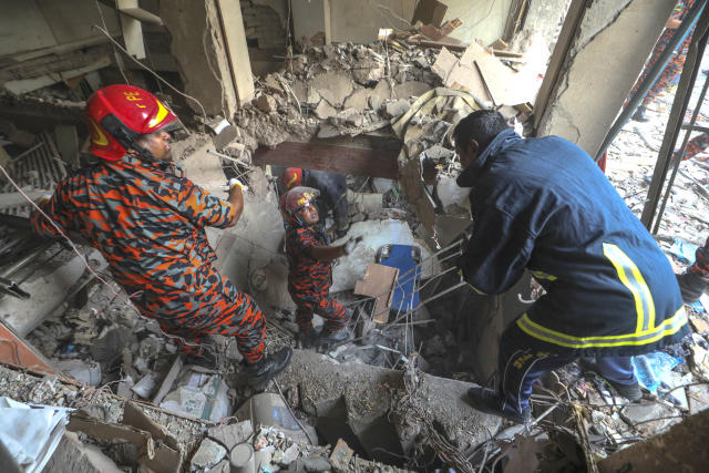 Fire officials look for survivors after an explosion, in Dhaka, Bangladesh, Tuesday, March 7, 2023. An explosion in a seven-story commercial building in Bangladesh's capital has killed at least 14 people and injured dozens. Officials say the explosion occurred in a busy commercial area of Dhaka. (AP Photo/Abdul Goni)