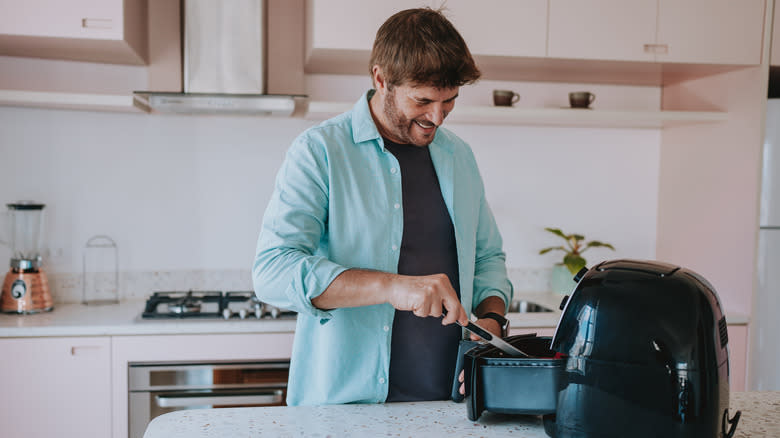 Person using air fryer