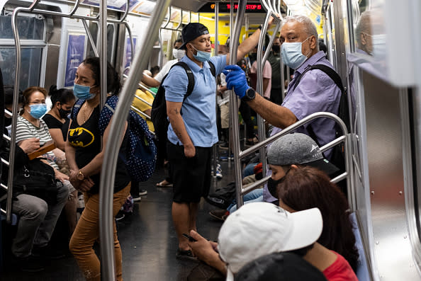 People stand in a subway train during rush hour amid the coronavirus pandemic in New York City. 