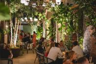 <p>One of London’s most iconic and beloved theatres also has a secret terrace, didn’t you know? <a href="https://thelane.co.uk/?gclid=Cj0KCQjw-JyUBhCuARIsANUqQ_JNwEcSb5m9o8t-lfF116llyjvR0tLLwUqVZejd1kVUJO94iN46HokaAsWCEALw_wcB&gclsrc=aw.ds" rel="nofollow noopener" target="_blank" data-ylk="slk:The Lane;elm:context_link;itc:0;sec:content-canvas" class="link ">The Lane</a>, situated just behind the theatre, is a passageway lined with trees and leafy green plants home to tables for drinks and snacks for theatre dwellers and passers by. Part of the Theatre Royal’s £60m makeover by Andrew Lloyd Weber himself, this is an ideal central London drinking and eating spot that’s hidden away from the crowds too. </p><p>Wines include favourites like Whispering Angel while snacks offered include potted shrimp and crudités. If that’s not enough to tempt you, east London favourite chef Lily Vanilli’s gluten free chocolate cake and salted caramel chocolate brownie are on the menu too.</p>