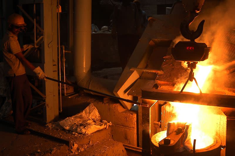 An employee works inside a steel factory in Lucknow