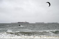 A wind surfer surfs in the rain in Long Beach, Calif., on Monday, Oct. 25, 2021. (Brittany Murray/The Orange County Register via AP)