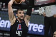 Los Angeles Clippers center Ivica Zubac dunks the ball against the Charlotte Hornets during the first half of an NBA basketball game in Charlotte, N.C., Thursday, May 13, 2021. (AP Photo/Jacob Kupferman)