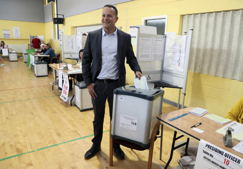 Taoiseach Leo Varadkar casts his vote at Scoil Thomais, Castleknock as people across the Republic of Ireland go to the polls to vote in the European and local elections along with the referendum on Ireland's divorce laws, in Dublin, Friday May 24, 2019. (Brian Lawless/PA via AP)