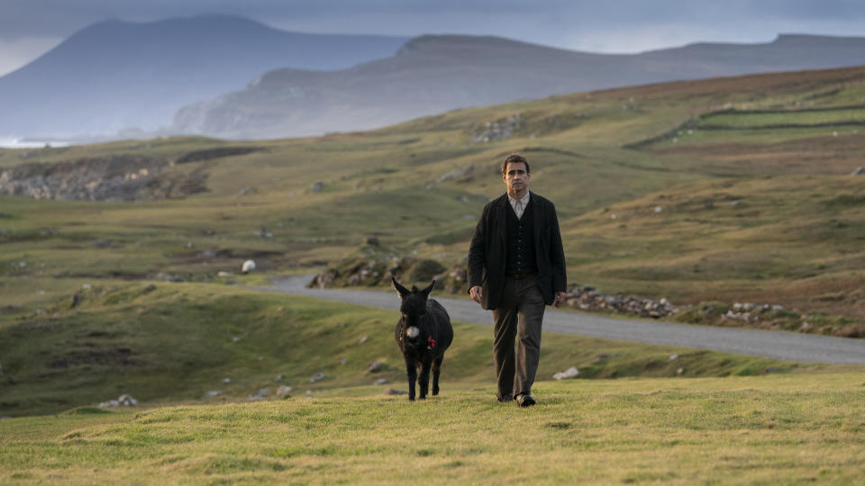 Colin Farrell in the film with a donkey during the filming of The Banshees of Inisherin. (Searchlight Pictures)