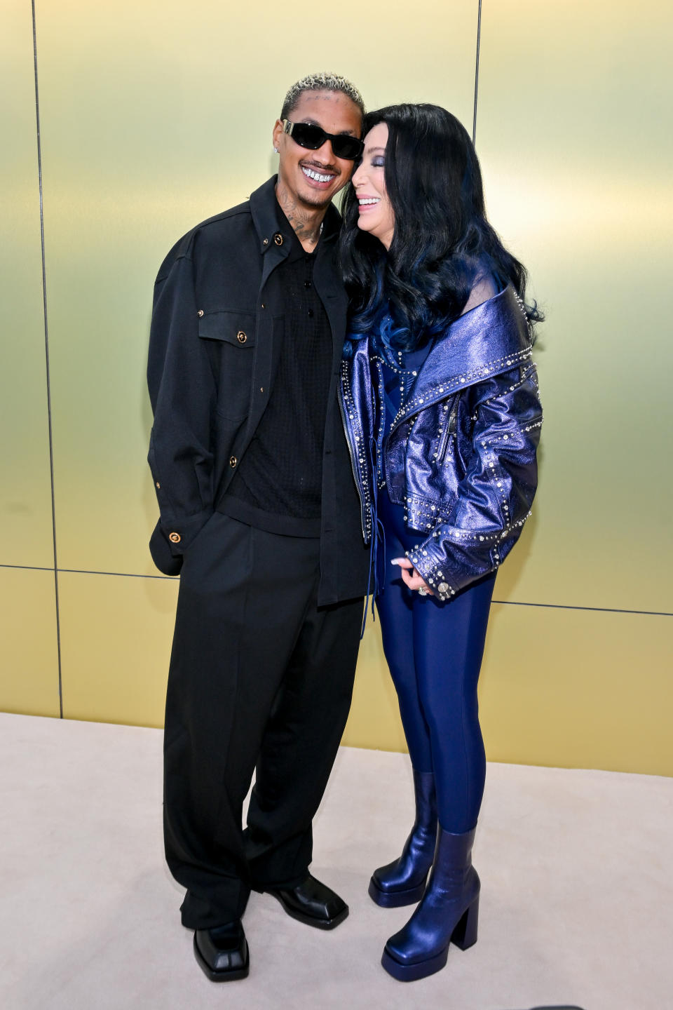 Alexander “A.E.” Edwards and Cher at the Versace Fall-Winter 2023 Fashion Show held at Pacific Design Center on March 9, 2023 in West Hollywood, California.