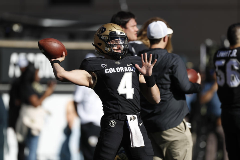 FILE—Colorado quarterback Sam Noyer warms up before an NCAA college football game Saturday, Nov. 9, 2019, in Boulder, Colo. Noyer, who left the university in search of a chance to quarterback a team, has returned to Colorado to vie for the first-string play caller position after a call from the university's new football coaching staff. (AP Photo/David Zalubowski, File)