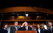 Chairman of the Senate Intelligence Committee Richard Burr (R-NC) and the committee's vice chairman Senator Mark Warner (D-VA)(2nd L) stand with members of the committee as they speak to the media about the committee's findings and recommendations on threats to election infrastructure on Capitol Hill in Washington, U.S., March 20, 2018. REUTERS/Joshua Roberts