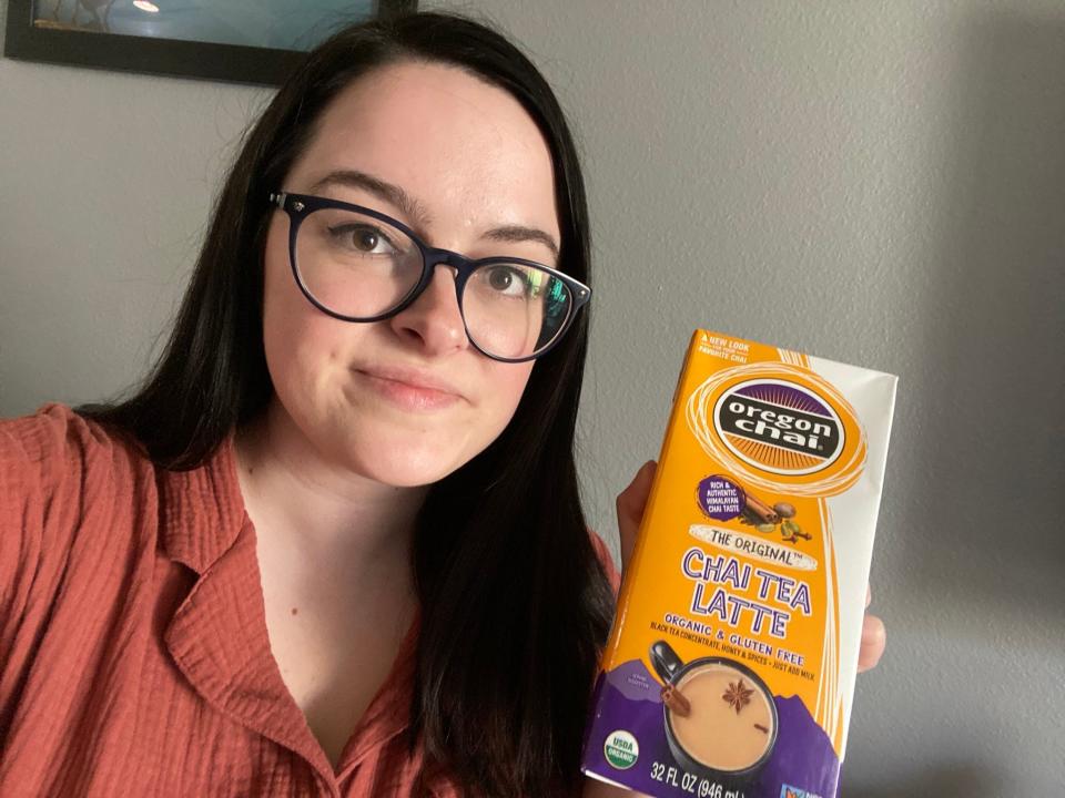 Author holding carton of Oregon Chai.