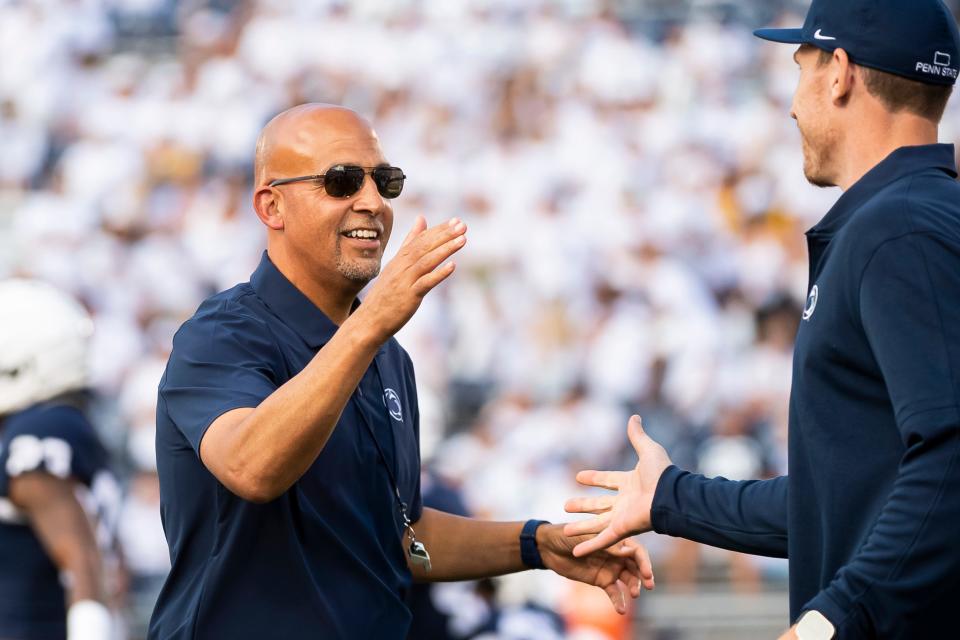Penn State head football coach James Franklin greets offensive line coach Phil Trautwein before the season opener against <a class="link " href="https://sports.yahoo.com/ncaaf/teams/west-virginia/" data-i13n="sec:content-canvas;subsec:anchor_text;elm:context_link" data-ylk="slk:West Virginia;sec:content-canvas;subsec:anchor_text;elm:context_link;itc:0">West Virginia</a> at Beaver Stadium September 2, 2023, in State College.