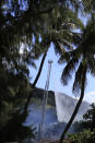 Firefighters spray water on several house fires burning in a Diamond Head neighborhood, Sunday, Jan. 19, 2020, in Honolulu, following a shooting in which two police officers were shot. (AP Photo/Marco Garcia)