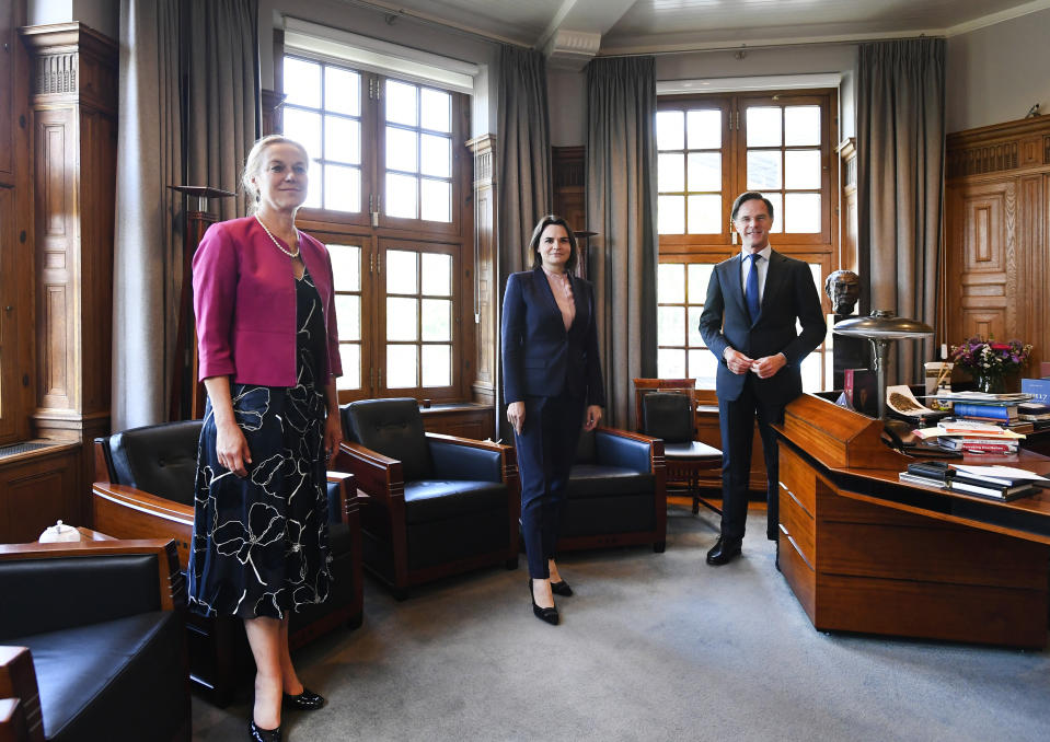 Sviatlana Tsikhanouskaya, former presidential candidate and main figurehead of the Belarus opposition, center, Dutch caretaker Prime Minister Mark Rutte, right, and caretaker Foreign Minister Sigrid Kaag, left, pose for a picture at the start of their meeting in The Hague, Netherlands, Friday, May 28, 2021. (Piroschka van de Wouw/Pool via AP)