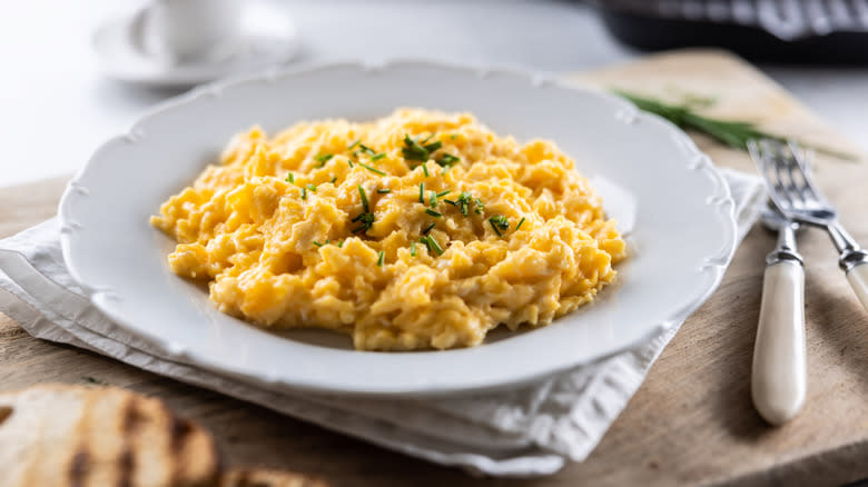 Scrambled eggs plate, chives, fork