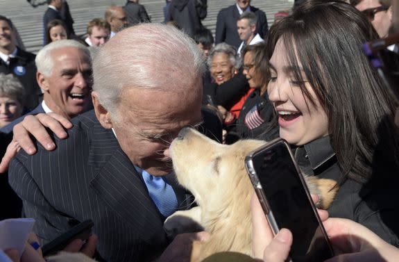 Copyright 2017 The Associated Press. All rights reserved. This material may not be published, broadcast, rewritten or redistributed without permission. Mandatory Credit: Photo by AP/REX/Shutterstock (8550214f) Former Vice President Joe Biden gets a kiss from a dog as he greets the crowd on Capitol Hill in Washington, following an event marking seven years since former President Barack Obama signed the Affordable Care Act into law Congress Health Overhaul, Washington, USA - 22 Mar 2017