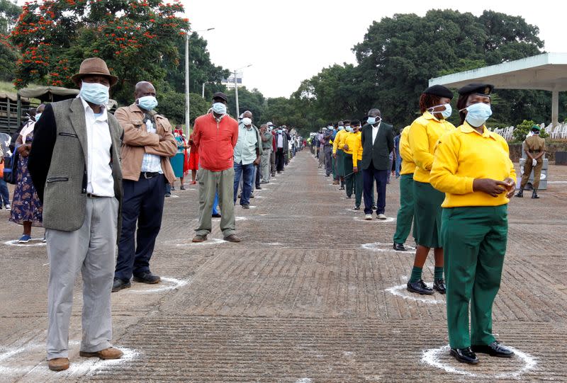 Workers of the Nairobi City County Government queue while observing social distancing to collect letters of redeployment by the Nairobi Metropolitan Services (NMS), amid concerns about the spread of coronavirus disease (COVID-19), in Nairobi