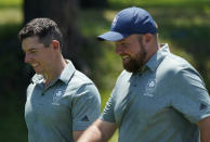 Ireland's Rory McIlroy and his teammate Shane Lowry speak during a practice round of the men's golf event at the 2020 Summer Olympics, Tuesday, July 27, 2021, at the Kasumigaseki Country Club in Kawagoe, Japan, (AP Photo/Matt York)