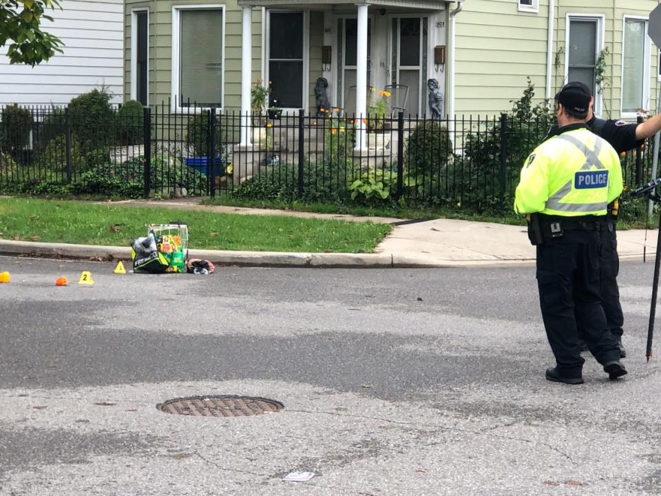 Evidence markers lay on the street where a pedestrian was struck on Oct. 15, 2021. (Dale Molnar/CBC - image credit)