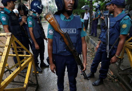 Policemen stand guard along a road leading to the Holey Artisan Bakery and the O'Kitchen Restaurant after gunmen attacked, in Dhaka, Bangladesh, July 3, 2016. REUTERS/Adnan Abidi