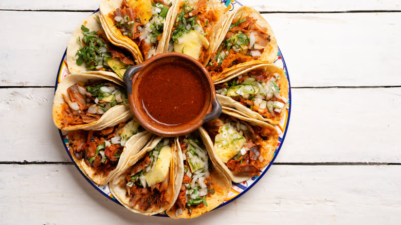 a plate of al pastor tacos