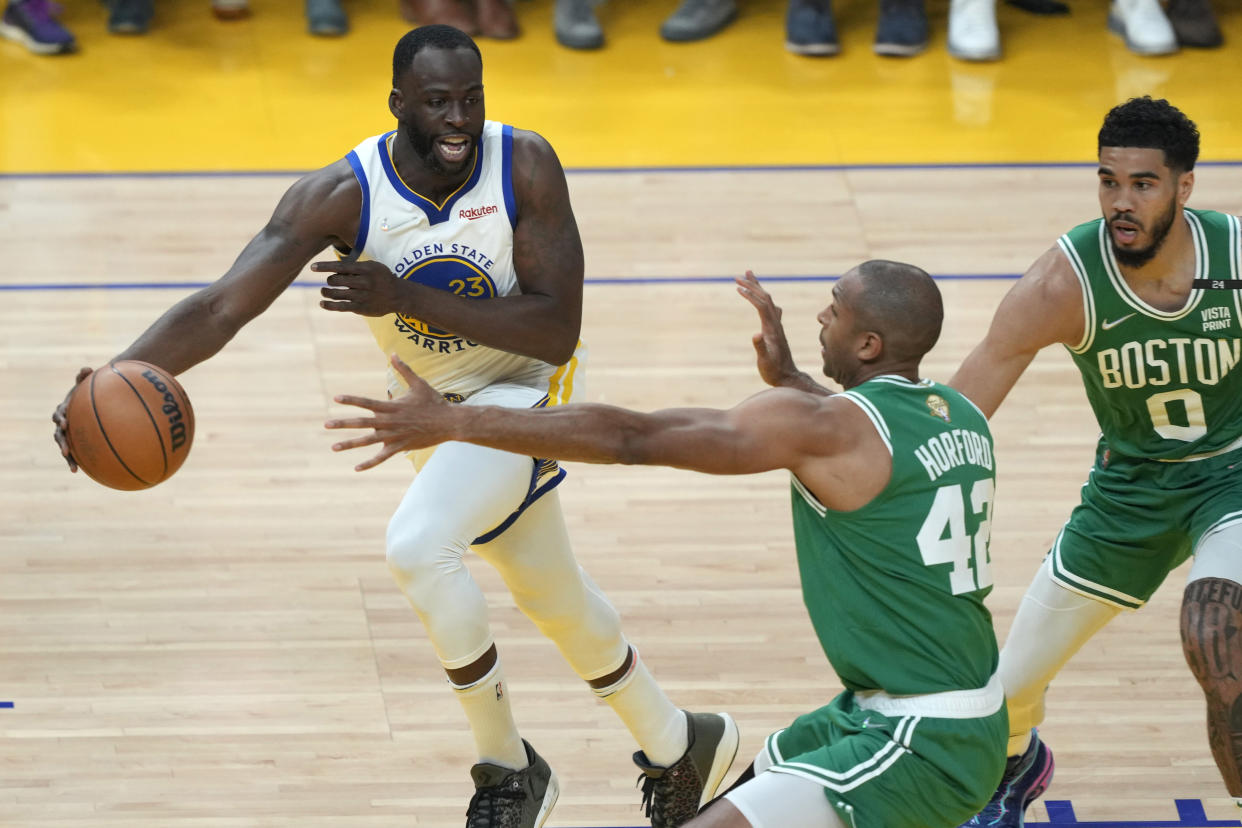 Golden State Warriors forward Draymond Green passes the ball against Boston Celtics' Al Horford and Jayson Tatum during Game 1 of the 2022 NBA Finals at Chase Center in San Francisco on June 2, 2022. (Thearon W. Henderson/Getty Images)
