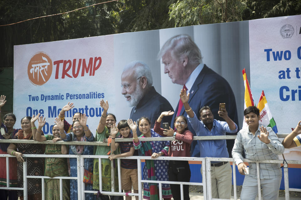 People line the street as the motorcade for President Donald Trump heads to a "Namaste Trump," event at Sardar Patel Gujarat Stadium, Monday, Feb. 24, 2020, in Ahmedabad, India. (AP Photo/Alex Brandon)