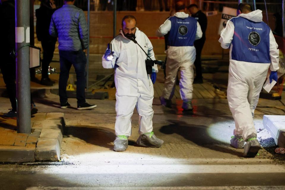 Forensic team members work at the scene of the shooting (Reuters)