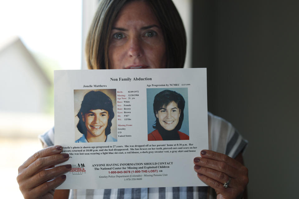 CORRECTS SPELLING OF FIRST NAME TO JONELLE INSTEAD OF JANELLE - FILE - In this Monday, Aug. 12, 2019, photograph, Jennifer Mogensen holds a poster of her adopted sister, Jonelle Matthews, who went missing and whose remains were found recently in Greeley, Colo. Steve Pankey, a former longshot candidate for Idaho governor, has been indicted in the murder of Jonelle Matthews, a 12-year-old Colorado girl who went missing in 1984. (AP Photo/David Zalubowski, File)