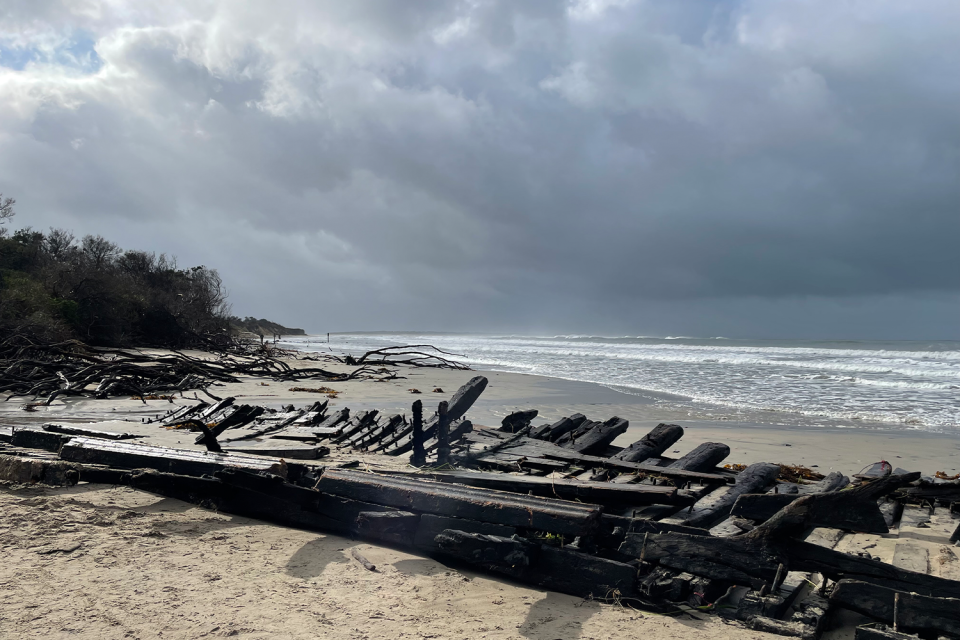 The Amazon wreck in the foreground with heavy clouds overhead.