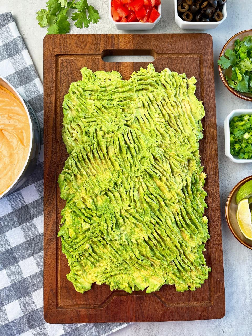 Smashed avocado is the base of your dip board.