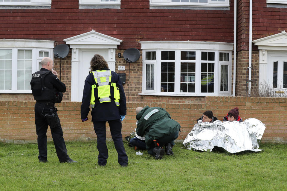 Police, Border Force and paramedics attend to migrants found following a search which was launched when an empty inflatable boat was found on Dungeness beach in Kent, England, Monday, Jan. 7, 2019. (Gareth Fuller/PAvia AP)