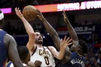 New Orleans Pelicans forward Zion Williamson (1) blocks a shot by Cleveland Cavaliers forward Kevin Love (0) during the first half of an NBA basketball game in New Orleans on Friday, Feb. 28, 2020. (AP Photo/Rusty Costanza)