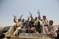 Houthi fighters react while riding on the back of a truck as they attend a tribal gathering in Yemen's capital Sanaa, August 11, 2016. REUTERS/Mohamed al-Sayaghi