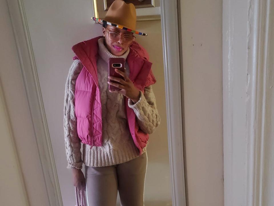 sandra wearing a pink puffer vest over a neutral outfit