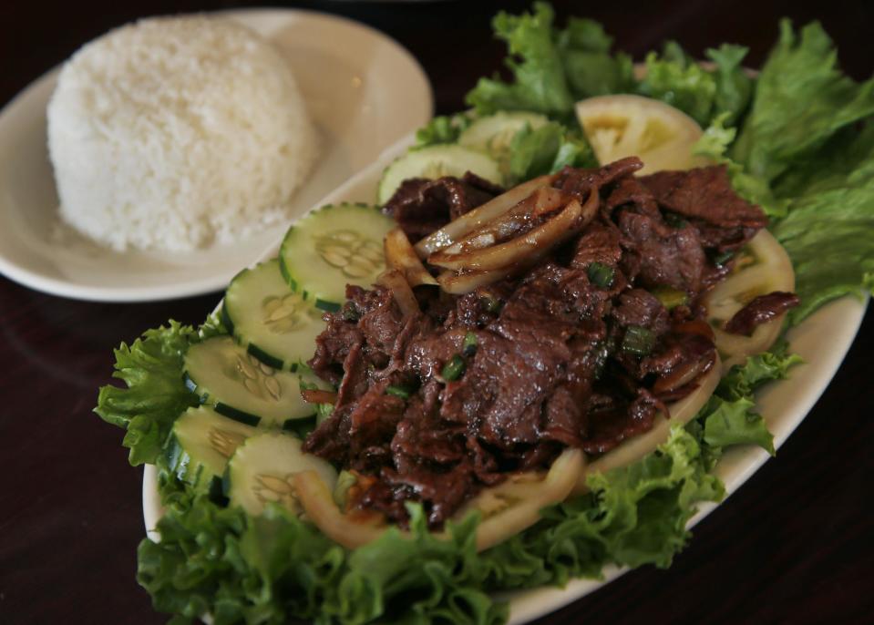 This March 14, 2014 photo shows a plate of beef loc lac at Simply Khmer, a Cambodian restaurant in Lowell, Mass. The classic Cambodian dish consists of seared beef that has been marinated and cooked in a savory sauce made with garlic, soy sauce, sugar and other ingredients. Simply Khmer is considered by some to offer the best _ and most authentic _ Cambodian food in Lowell. (AP Photo/Elise Amendola)