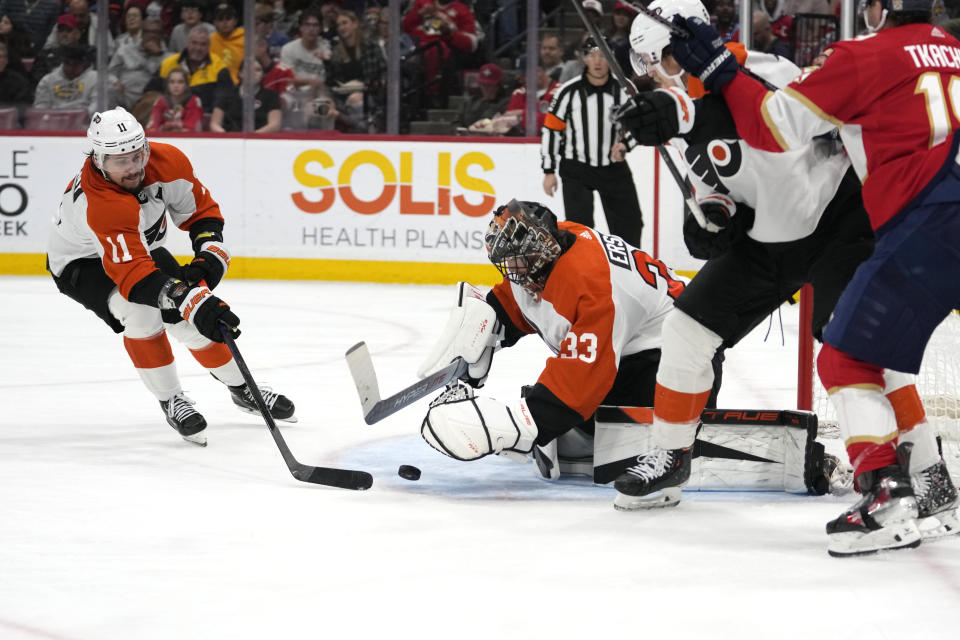 Philadelphia Flyers right wing Travis Konecny (11) and goaltender Samuel Ersson (33) defend the goal during the second period of an NHL hockey game against the Florida Panthers, Thursday, March 7, 2024, in Sunrise, Fla. (AP Photo/Lynne Sladky)