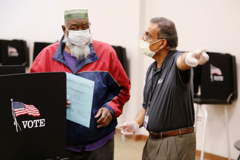 Voters line up to cast their ballots for the presidential primary elections in Columbus