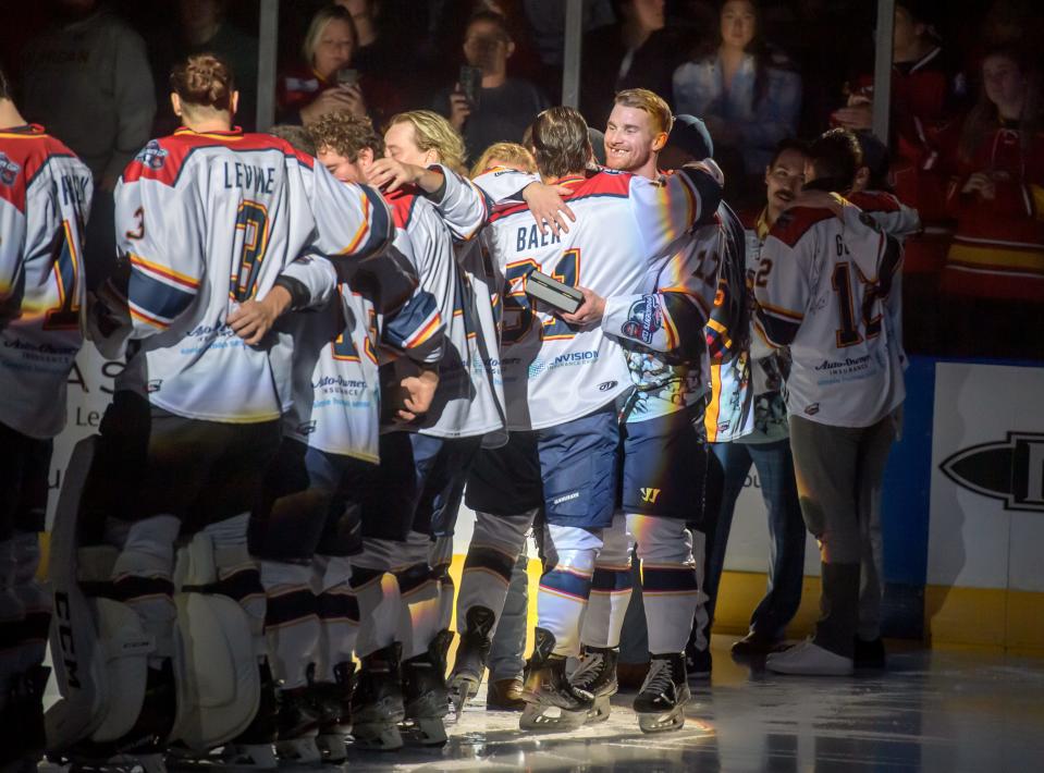 Peoria Rivermen captain Alec Hagaman, facing, embraces his teammates during the ring ceremony before the start of their home opener against rival Quad City Storm on Saturday, Oct. 22, 2022 at Carver Arena. The Rivermen received their SPHL championship rings and raised the banner during the ceremony.
