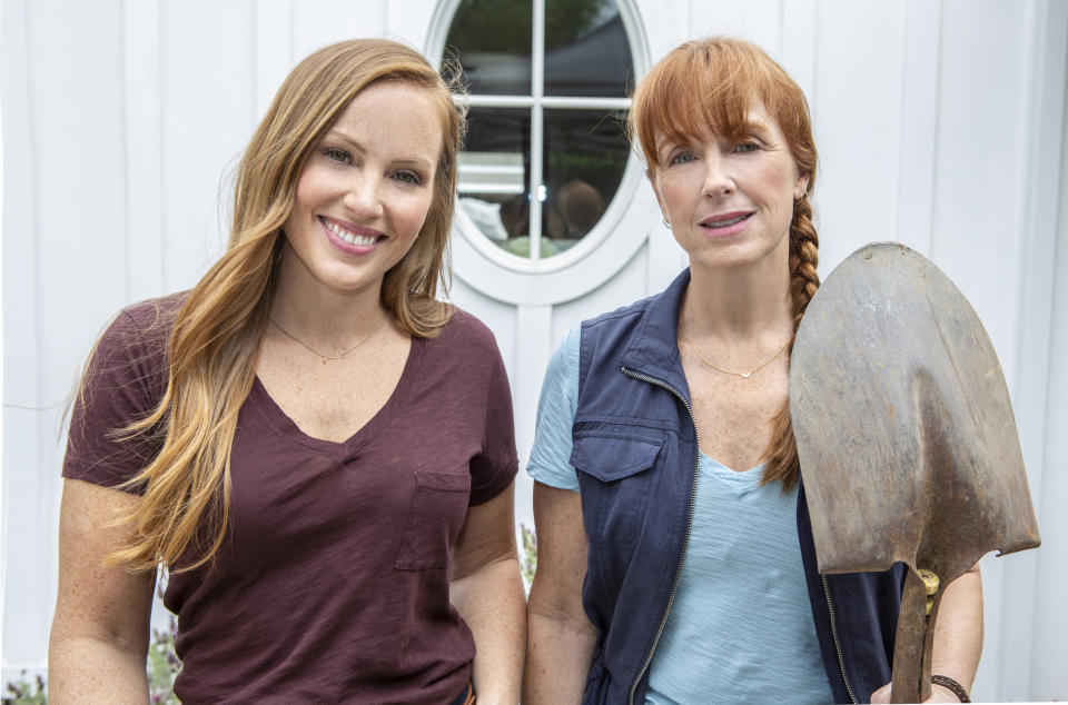 Karen E. Laine holds shovel while standing next to Mina Starsiak Hawk